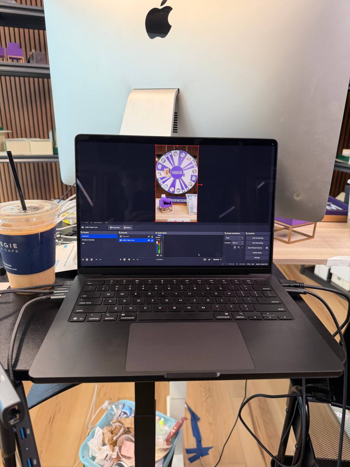 Laptop on a stand showing a streaming scene with a prize wheel